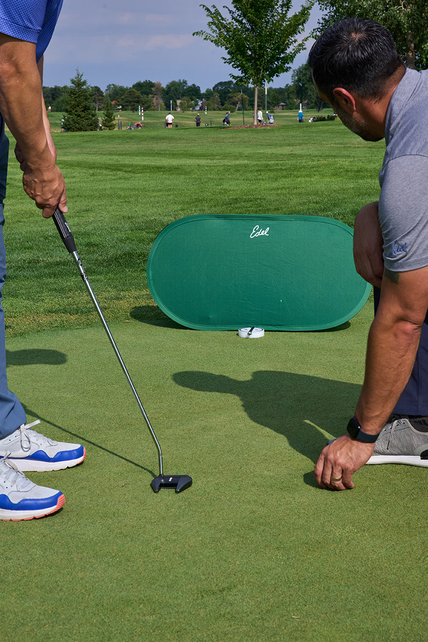 Edel Golf Aim Check w/ laser pointed on backdrop outside